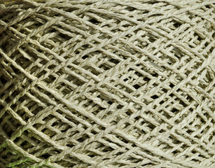 An olive skein of raffia is ready for knitting. Eco-friendly handmade material.