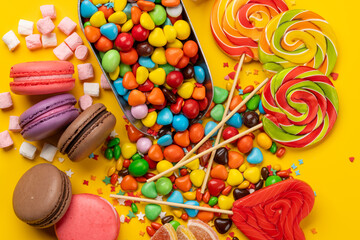 Various colorful candies, lollipops, and macaroons