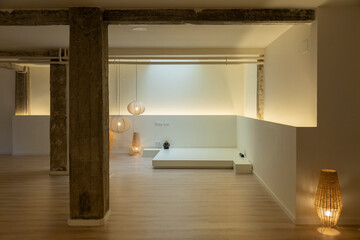 Elegant loft space with warm lighting and a minimalist platform.
