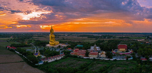 Aerial view of golden big Buddha at Wat Muang located in Ang-thong province of Thailand.