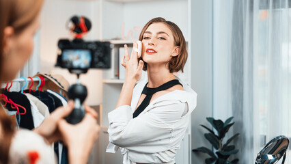 Woman influencer shoot live streaming vlog video review makeup utmost social media or blog. Happy...