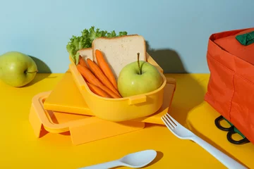 Keuken spatwand met foto Yellow lunch box with bread, apple and carrot © Atlas