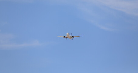 passenger plane in the blue sky - 786971539