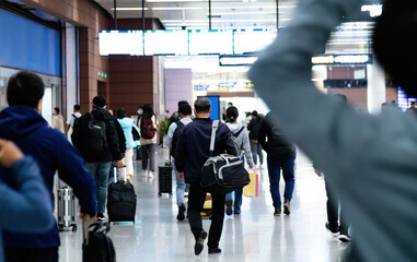 Back view of people walking at airport