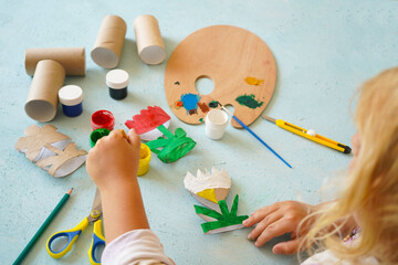 Kids craft flowers out of recycling toilet paper roll, zero waste concept. Step by step tutorial -...