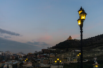 Evening view of Holy Trinity Cathedral of Tbilisi, Georgia from Narikala fortress. Bright sky and clouds. © Michael