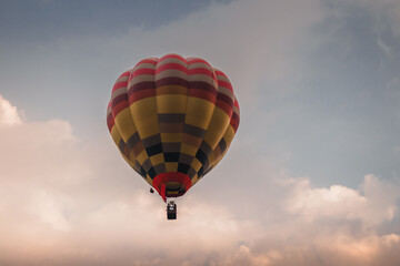 A hot air balloon flying at  sunset