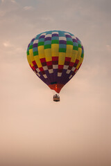 A hot air balloon in the sky at sunset