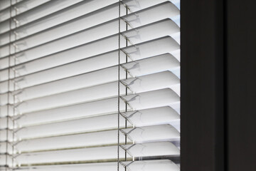 Window blinds texture. Closeup jalousie pattern. Parallel lines background. Sunlight protection. White office window.