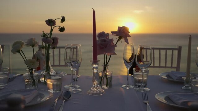 Flowers and candleslight decoration sunset wedding beach.