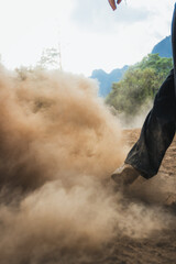 Kicking a dusty road
