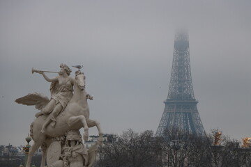 Eiffel Tower and sculptures shrouded in fog
