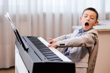 Singing and Playing Piano. Funny Little Pianist with Open Mouth and Close Eyes Play Piano. Happy...