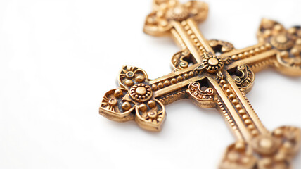 Ornate golden cross with intricate designs and patterns, on a white background.
