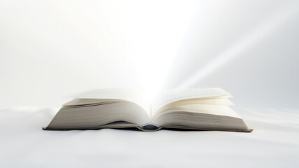 An open book bathed in a divine light against a white background, pages fluttering.