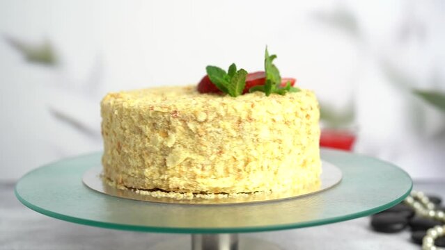 Delicious fresh Napoleon cake with fresh strawberries close-up.