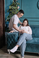 A young married couple of different nationalities, a family photo session with the pregnant wife