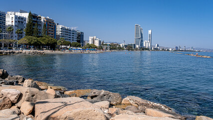 View of Limassol beach and the frontline of buildings and skyscrapers along the promenade park and coast, Limassol, Cyprus - obrazy, fototapety, plakaty