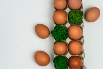 Homemade fresh eco eggs in paper packaging and natural moss. Top view, space for text. natural food product concept.