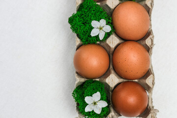 Homemade fresh eco eggs in paper packaging and natural moss. Top view, space for text. natural food product concept.