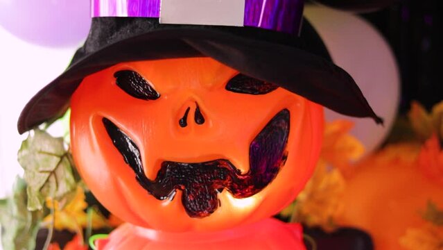 plastic pumpkin with halloween lantern shaped hat in colorful decoration