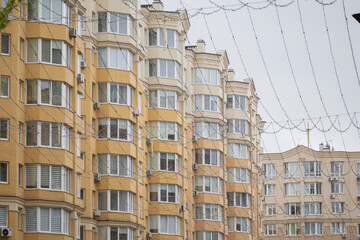 Sofiivska Borshchahivka, Ukraine. April 16, 2024 Good variety of houses in residential complex. gray cloudy sky and flowering trees in the area. many cars are parked and people are walking.