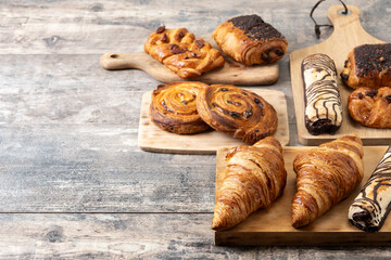 Set of bakery pastries on wooden table. Copy space