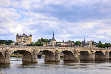Saumur, France, located at the Loire river under a beautiful cloudscape during daytime.