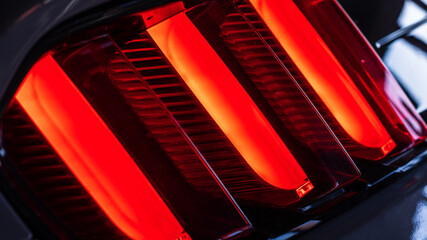 Red LED taillight of a modern sports car, close up photo of vehicle details