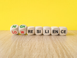 Turned wooden cubes and changes red words 'low resilience' to 'high resilience'. Beautiful yellow...
