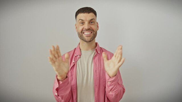 Young hispanic man in shirt, ecstatically cheering his big win! handsome fellow on white background, oozing joy and positivity with winning smile.