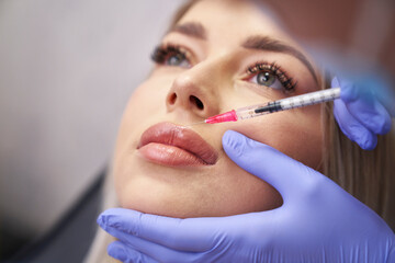 Woman having facelifting procedure in beauty salon - 787017986