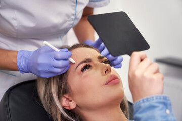 Woman having facelifting procedure in beauty salon - 787018123
