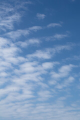 Natural pattern. Cloudy blue sky background. Calm sky and bright clouds in sunlight.