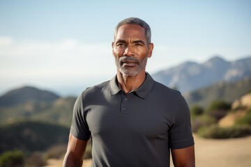 Portrait of a glad afro-american man in his 50s donning a classy polo shirt isolated in panoramic...