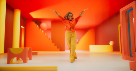 Beautiful Black Woman in Bright Outfit Dancing Energetically in Geometric Abstract Orange, Yellow...