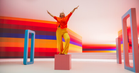 Portrait of a Talented Black Female Artist Showcasing Dance Movements in Abstract Colorful Studio Decoration. African Woman Expressing Emotions with Her Innovative Modern Dance Routine