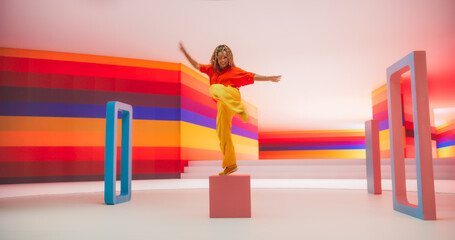 Portrait of Talented Black Female Artist Showcasing Dance Movements in Abstract Colorful Studio...