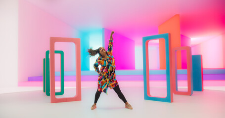 Beautiful Smiling Black Woman Dancing Energetically in a Colorful Abstract Neon Lit Studio....