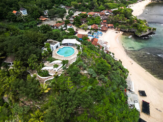 Aerial view of white colored luxury hotel or resort buildings with swimming pool in a hilltop...