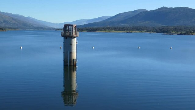Plasencia, Spain - February 16, 2024 - The tower in the middle of the swamp to control the flow of water from the Jerte river, in the background the Jerte Valley