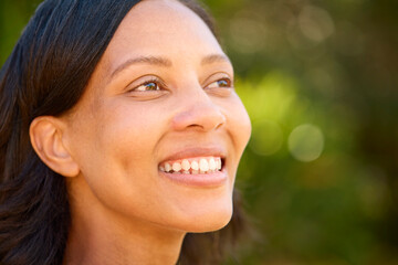 Close Up Portrait Of Smiling Woman Standing Outdoors In Summer Countryside Or Garden