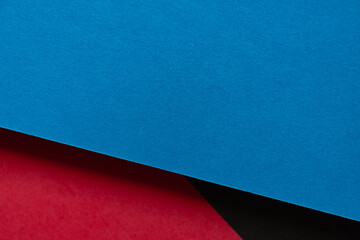 青と赤と黒の重なった画用紙の背景 - obrazy, fototapety, plakaty