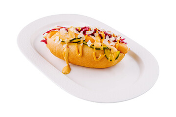 Gourmet hot dog with toppings on white plate