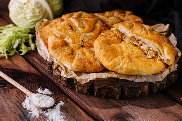 Rustic homemade cabbage pie on wooden table