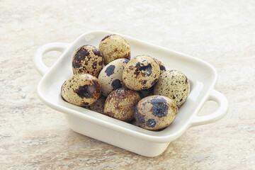 Raw quail eggs heap in the bowl