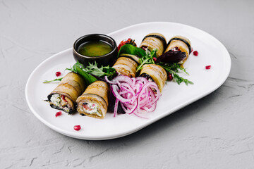 Gourmet eggplant rolls with fillings on elegant plate
