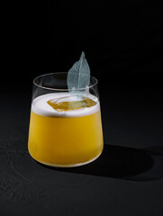 Elegant cocktail with a decorative leaf garnish
