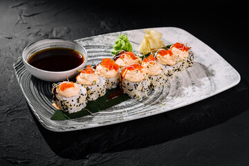 Exquisite sushi roll platter with dipping sauce