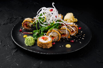 Gourmet sushi roll platter on black slate